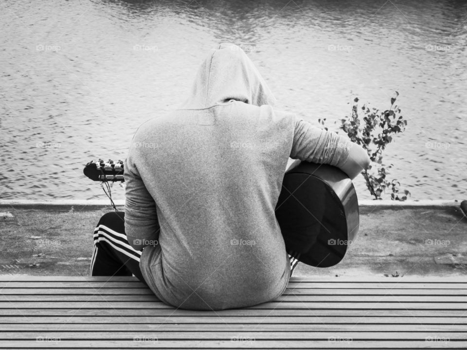 Playing the guitar by the river