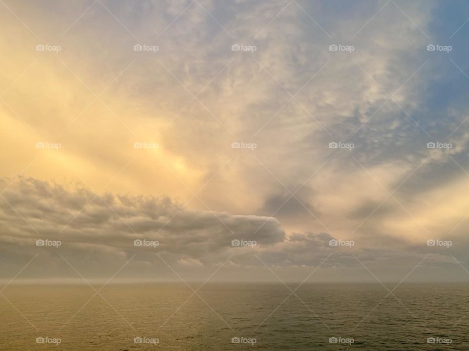 Clouds and fog over the ocean at sunset 