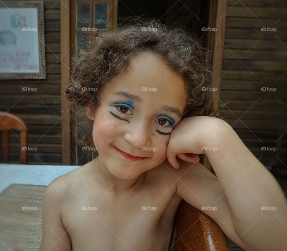 Smiling girl playing with makeup