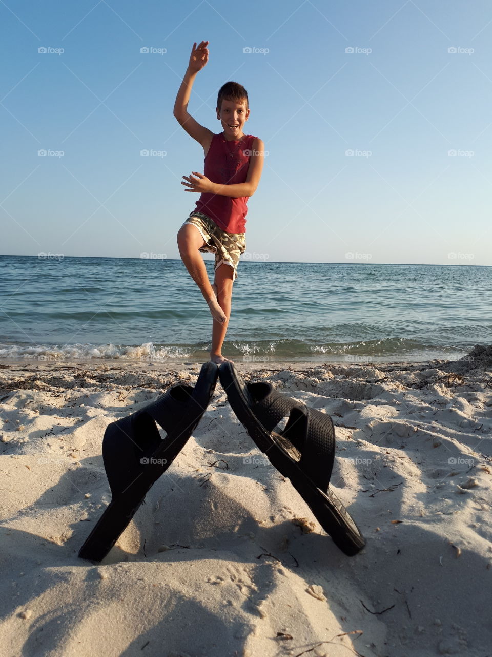 Teenager doing yoga at the beach