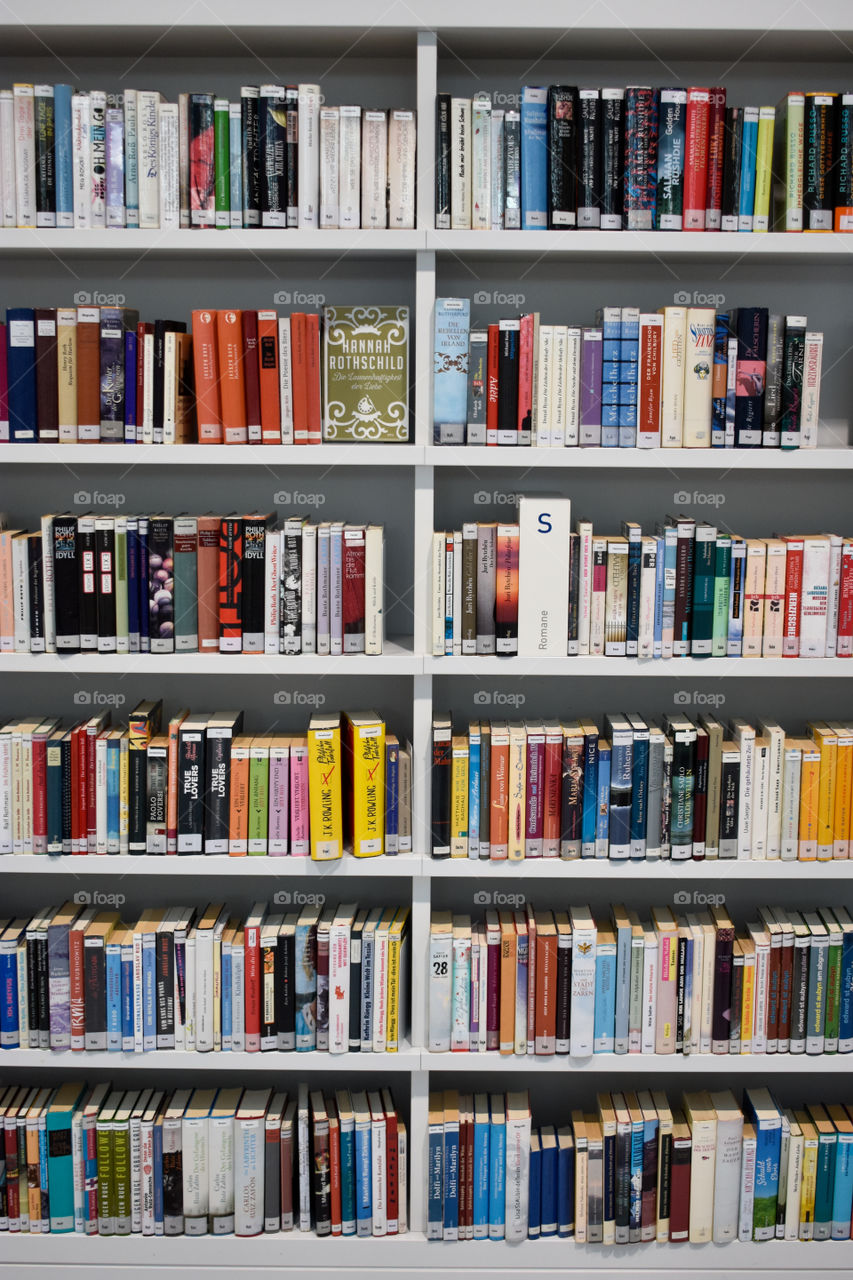 bookshelf with many books in a library