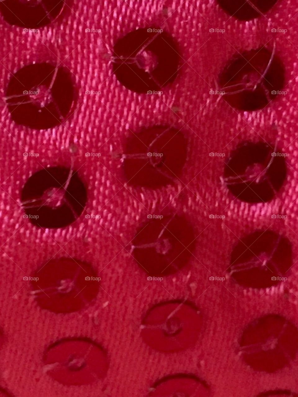 Sequins on satin. Pink. Close up. 