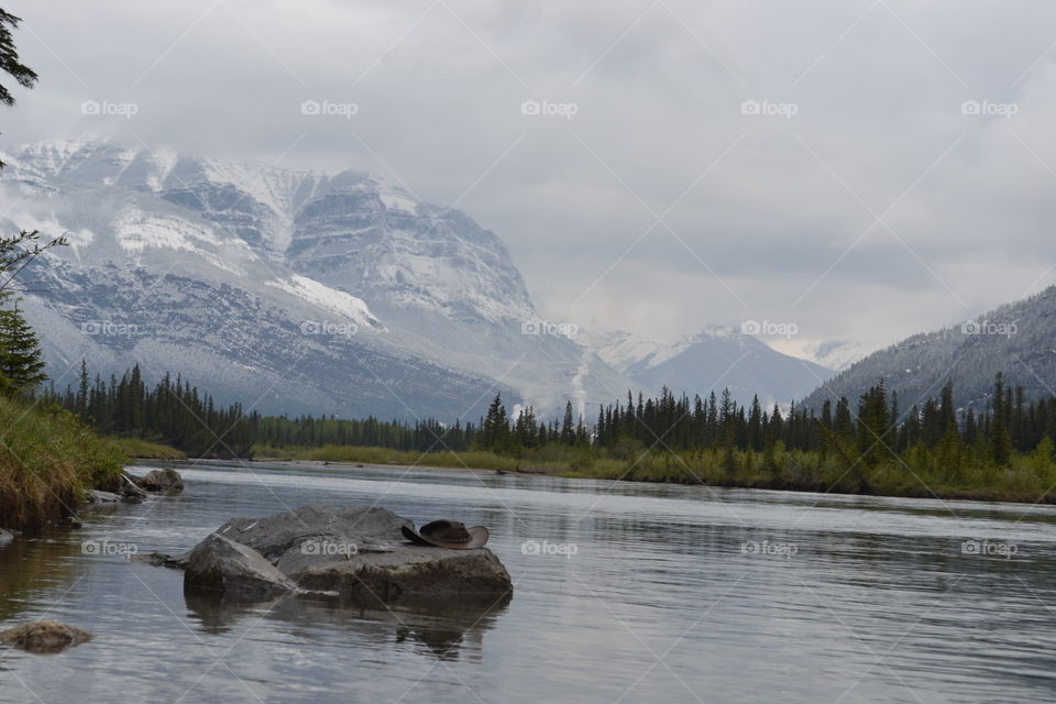 Hat on rock in lake at Canada