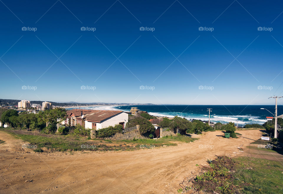 Beautiful town of Chile named El Tabo, the picture shows one of its streets and the Pacific Ocean 