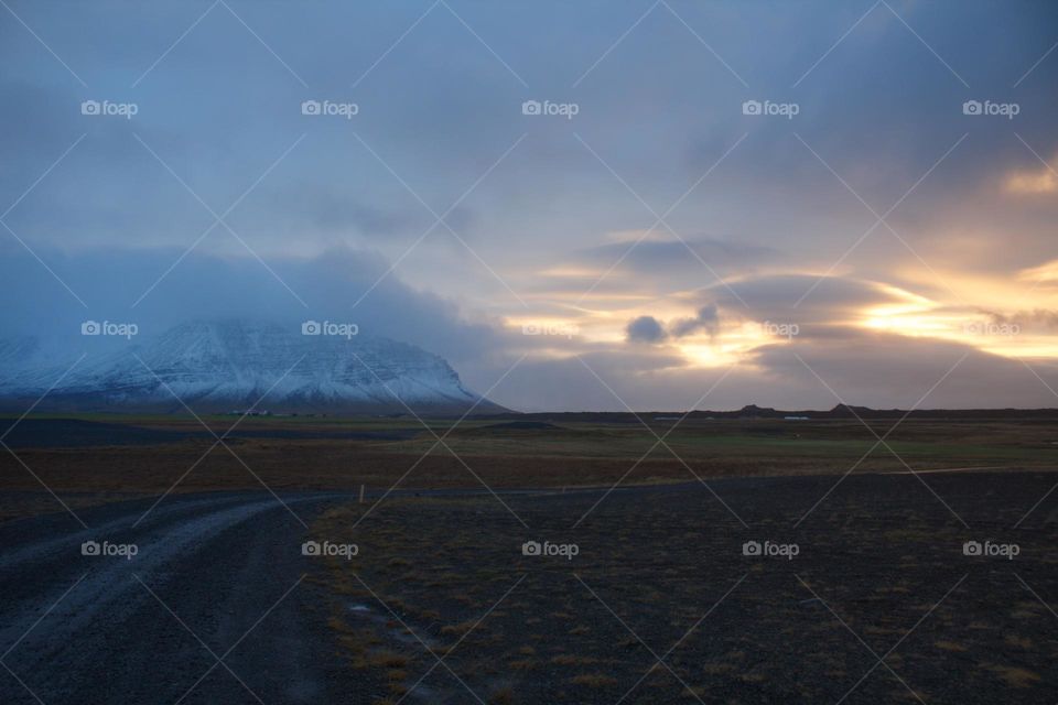 Magic sunrise in Iceland with snow-covered mountain in the background.