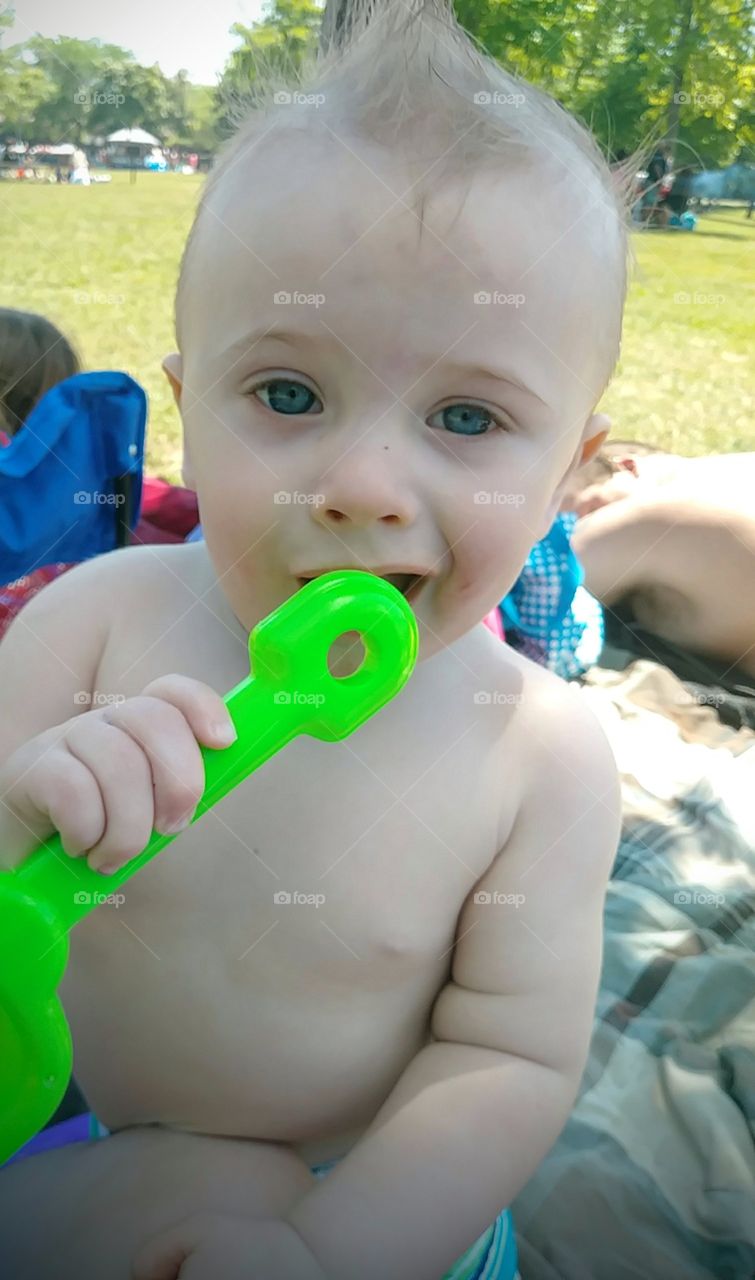 Bruce Willis doppelganger baby boy on a happy summer day at the beach.