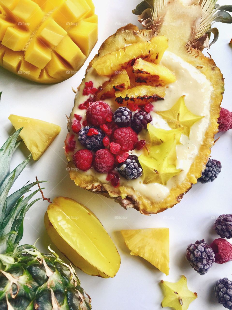 Smoothie with pineapple, starfruit and berries