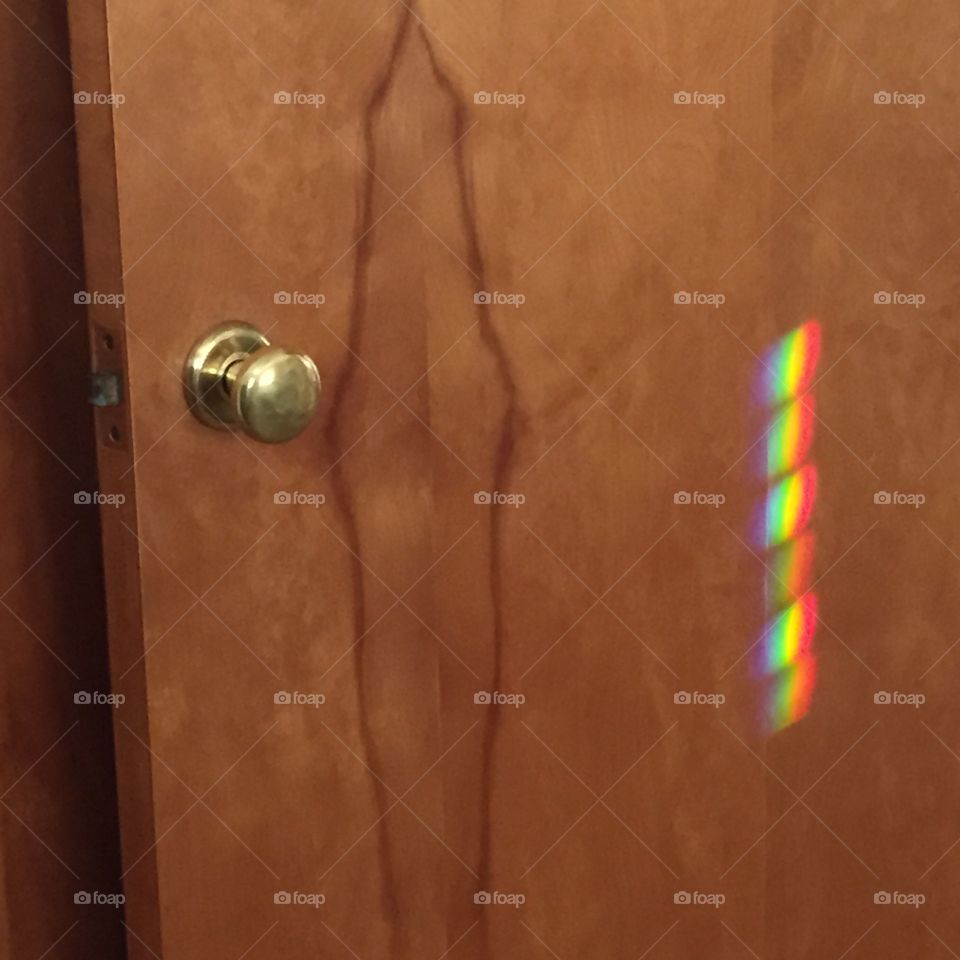 Rainbow reflection on woodgrain door