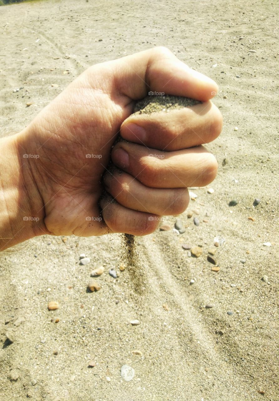 sand. hand. summer