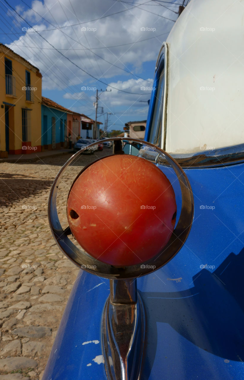 Rear light of a classic American car on street in Trinidad, Cuba on sunny day in December 2013.