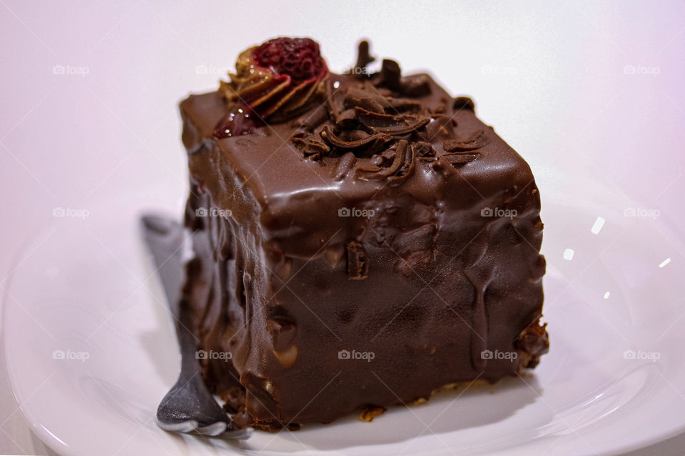 Chocolate mousse with raspberries on a white plate