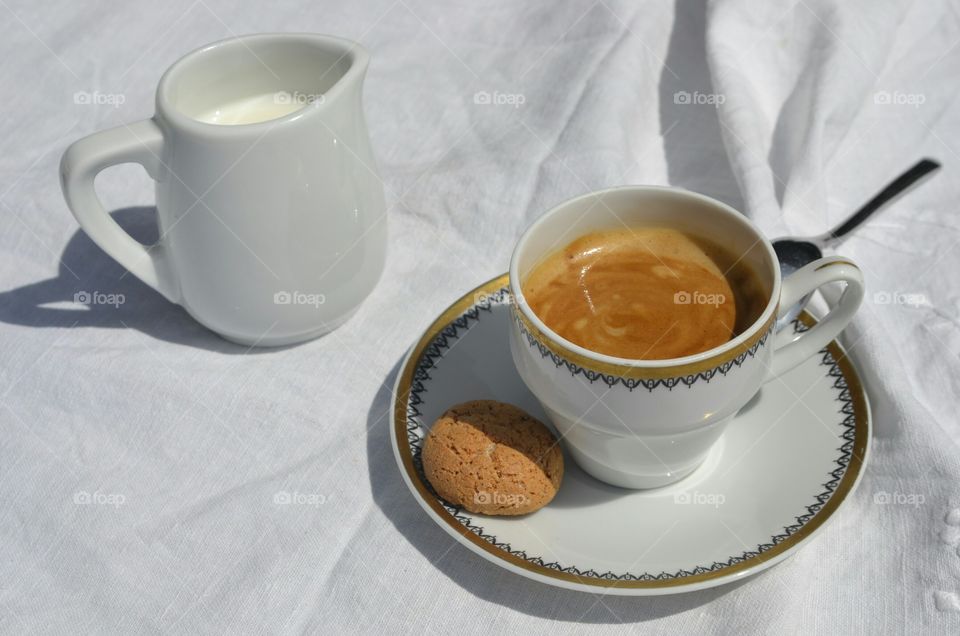 High angle view of cup of tea and cookie