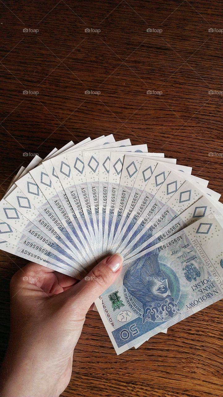 Polish paper money. Hand holding polish paper money