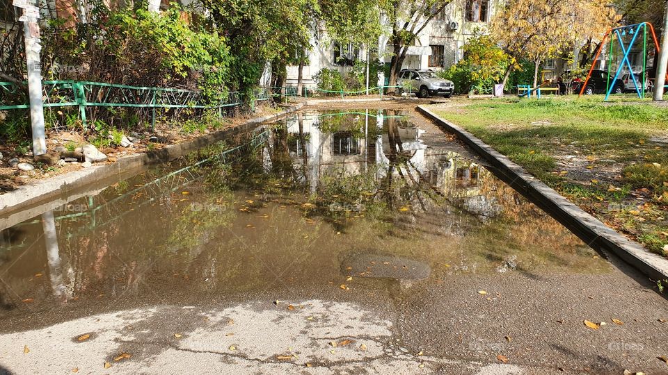 reflections on a road in residential area after rain
