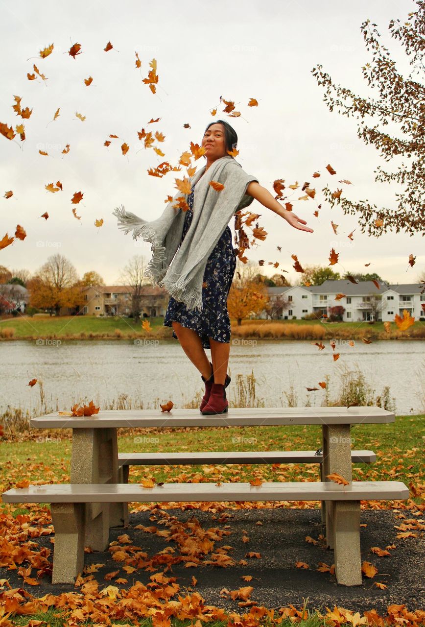 the falling leaves and woman dancing with the wind