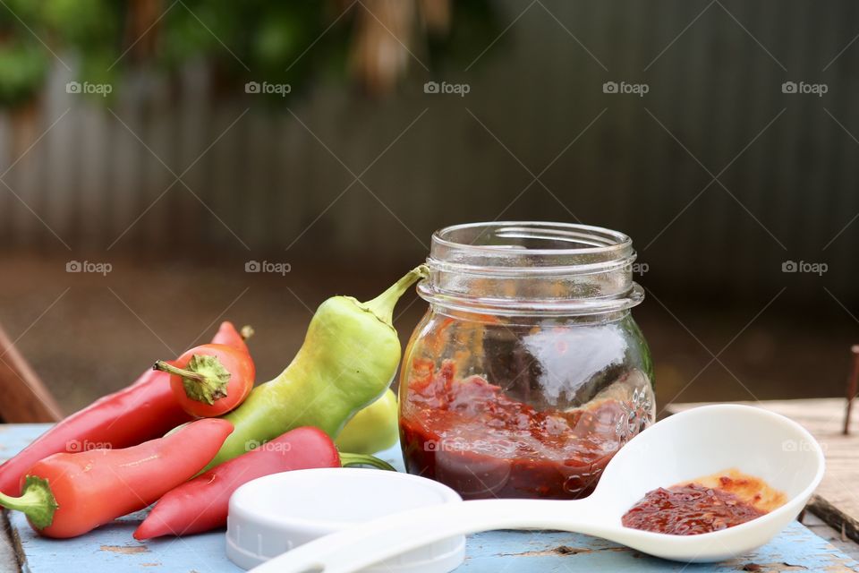 Homemade chopped child preserves, rustic, outdoor pint jar and white label, fresh peppers 