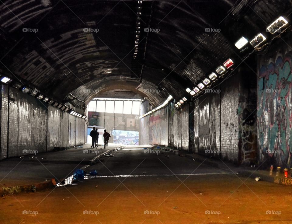 Silhouette of people running in tunnel