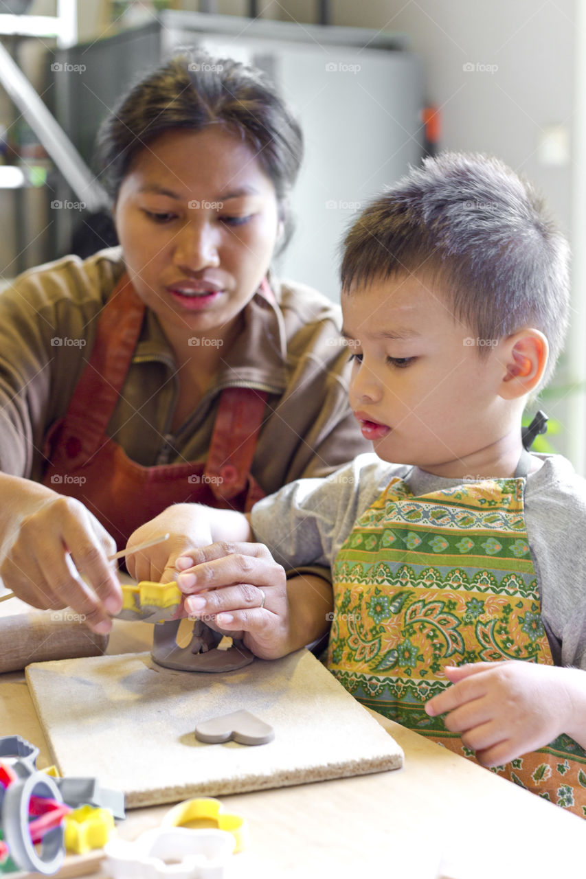 Mother and son doing ceramics