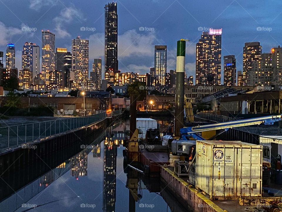 Skyscrapers of downtown Brooklyn reflected in the Gowanus Canal