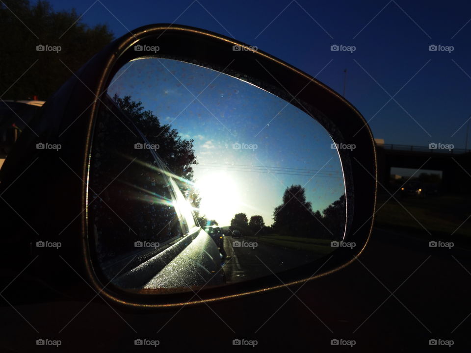 Illuminating the teflective sunlight in a car mirror