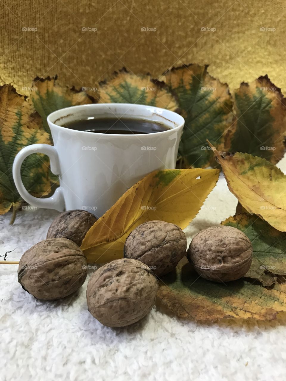 The white cup of coffee in the autumn vibes.