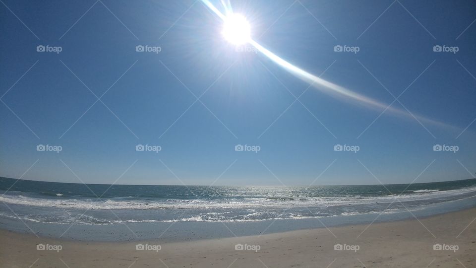ocean sea waves and blue sky with sun shine