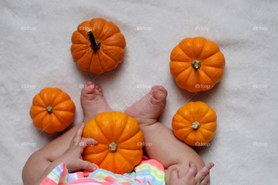 baby and pumpkins