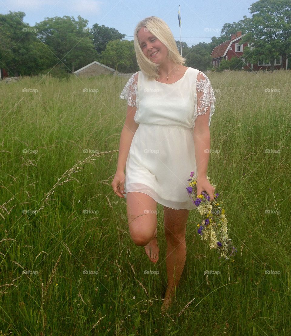 Woman in grass at midsummer 