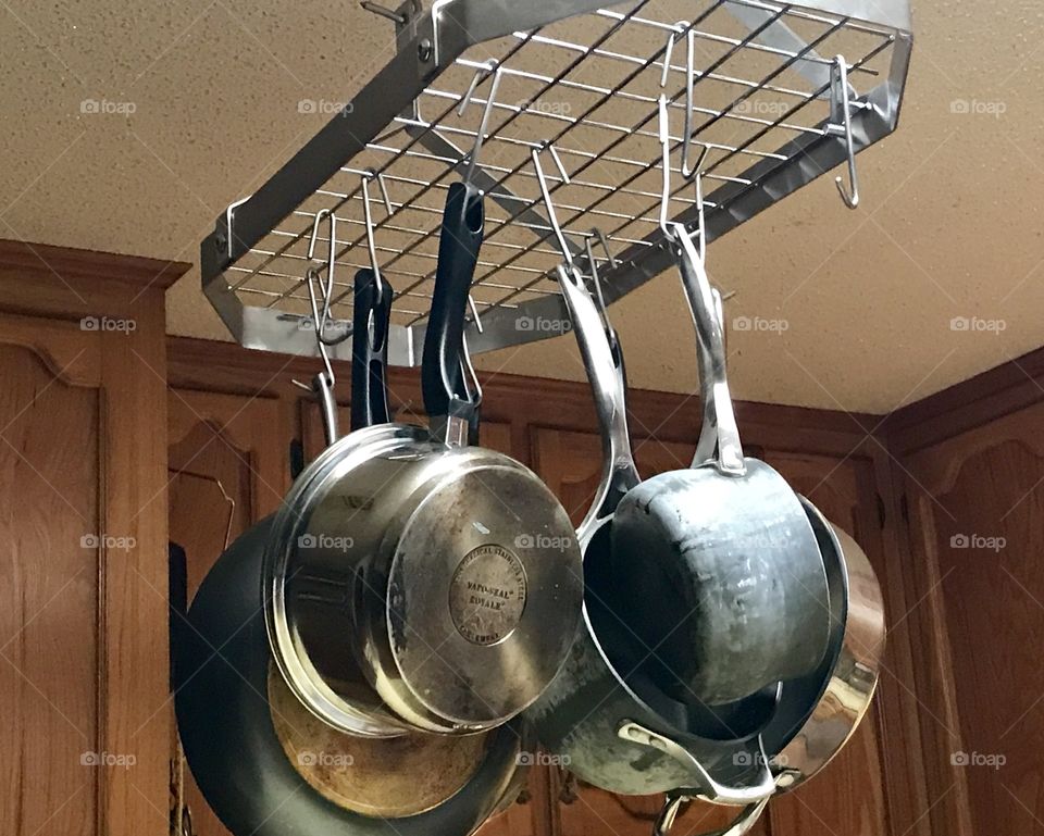 Pots and pans hanging from a stainless steel rack