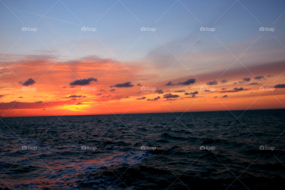 sunset sky eminates colors in frenzy over the ocean