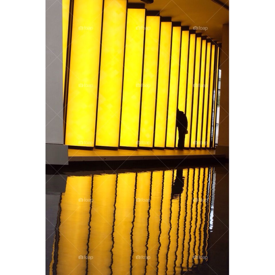 Curiosity . A man in yellow lights 