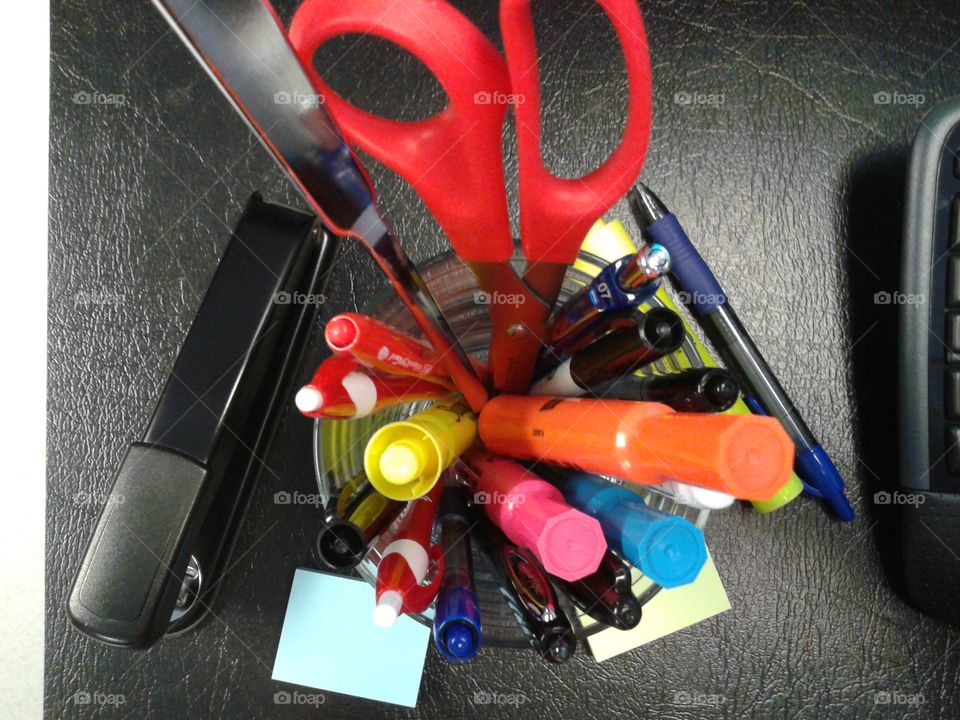 View from abov
e, a pencil cup with all the colorful writing implements you would find at the office.