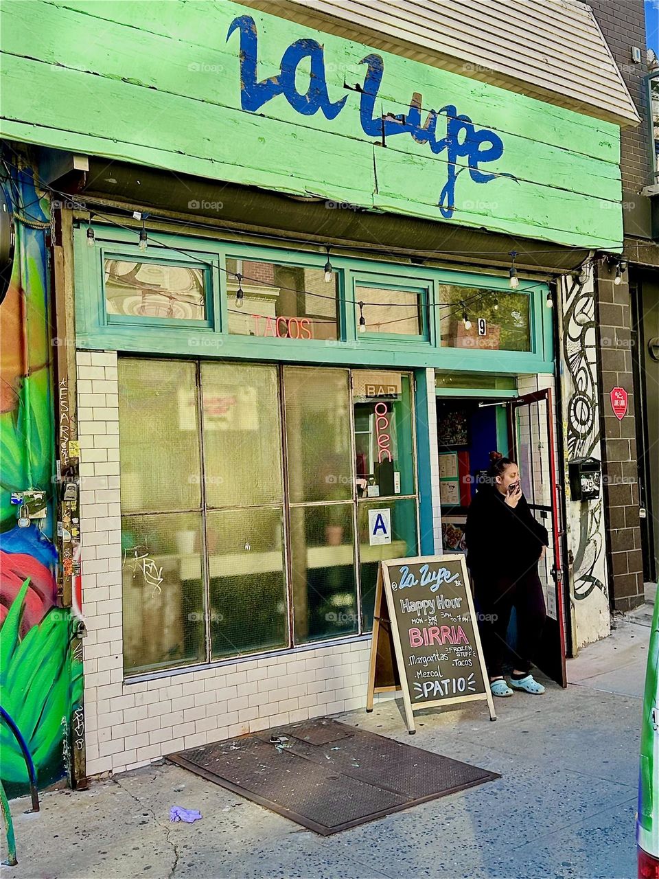 This is “La Lupe”, a popular club restaurant on “Jefferson Street” off “Broadway” in “Bushwick”, Brooklyn next to the nearly a city block long Latin “PRIDE” mural. 2024. Hypnotic Productions