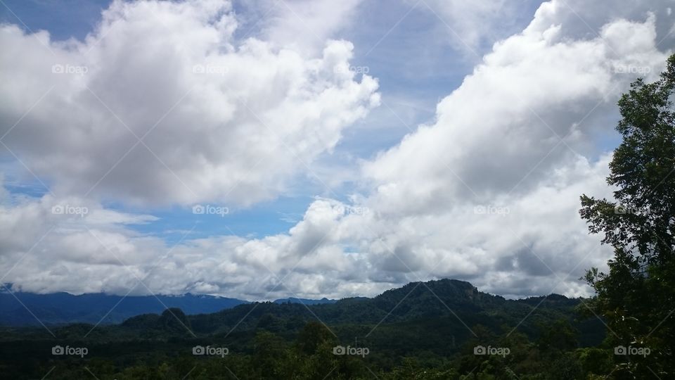 Bright blue skies and fluffy white clouds at the Jagoi village hike.