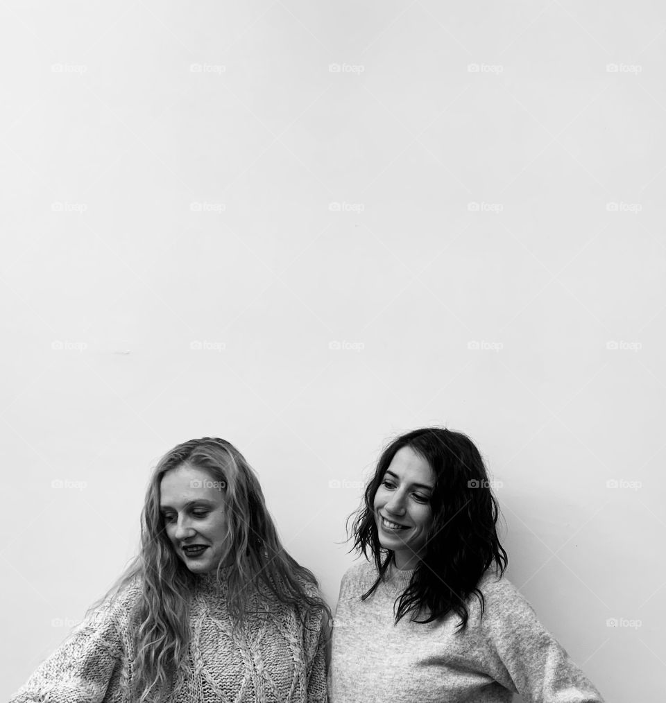 Two girls sisters in sweaters 