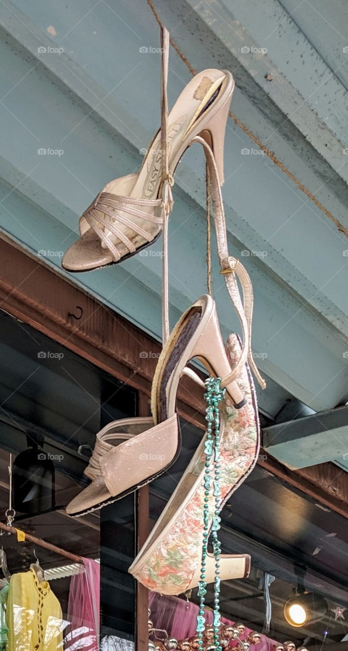 High heel shoes hanging outside a consignment store