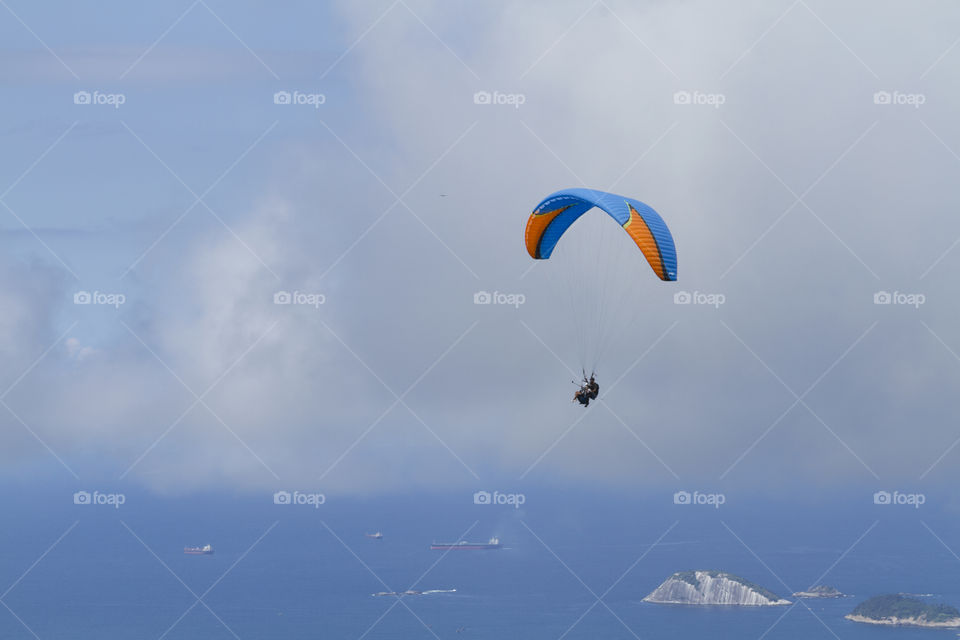 Paraglider flying over Sao Conrrado in Rio de Janeiro Brazil.