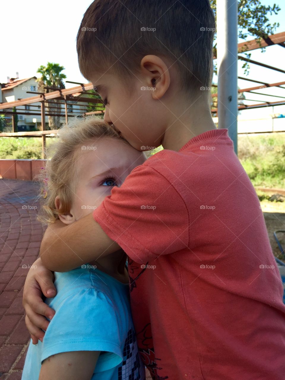 Brother hugging his sister
