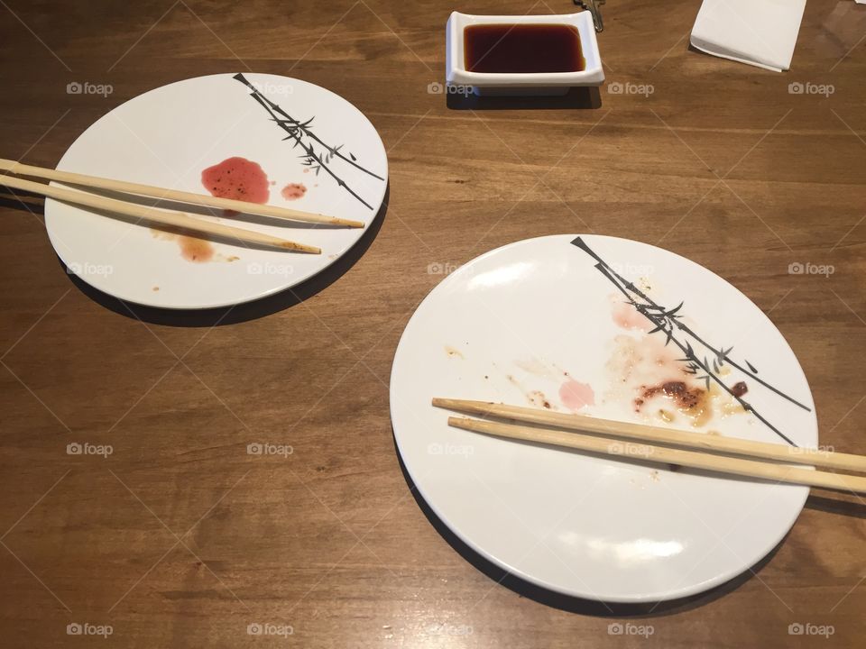 Empty plates of sushi with chopsticks