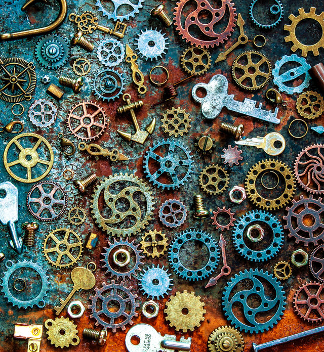 Metallic themed flat lay, featuring cogs, keys, nuts, bolts, clock hands