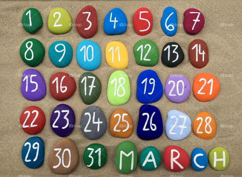 March, calendar on colored stones 
