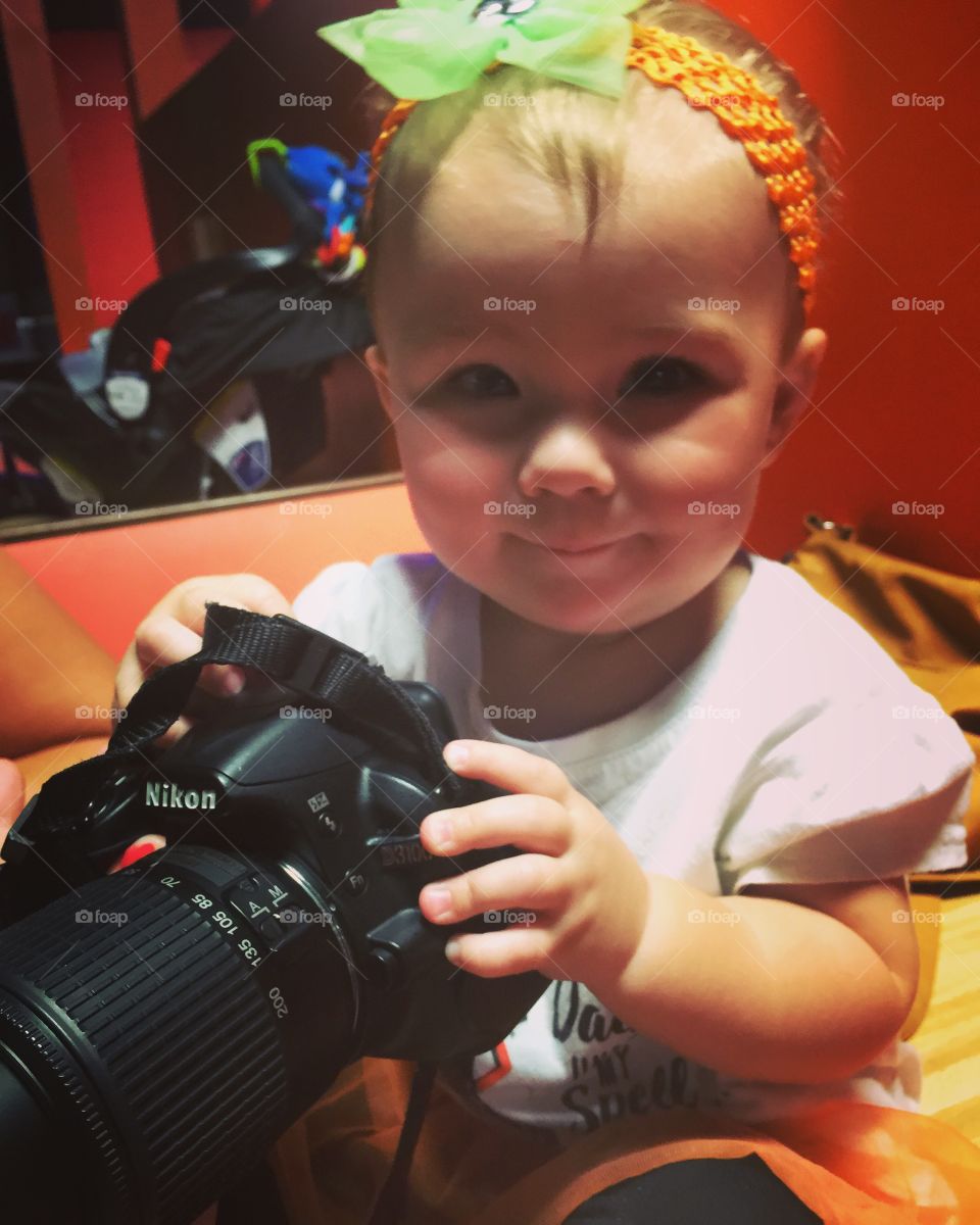 Close-up cute girl holding camera