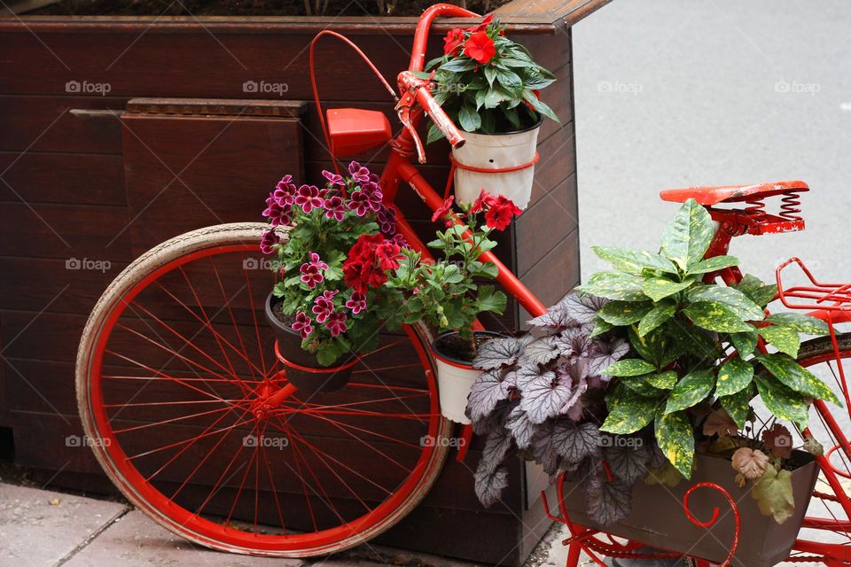 Red bike and flowers decoration on the street