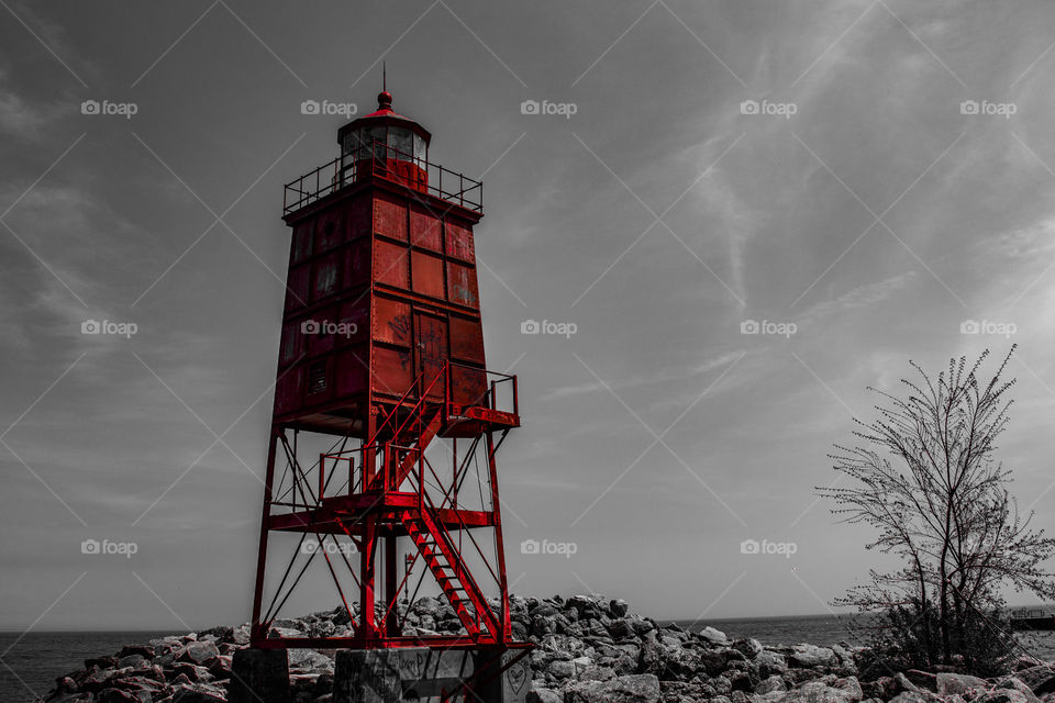 Open your eyes to see things the way they are meant to be seen. This red lighthouse lays nice upon the black and white background.  