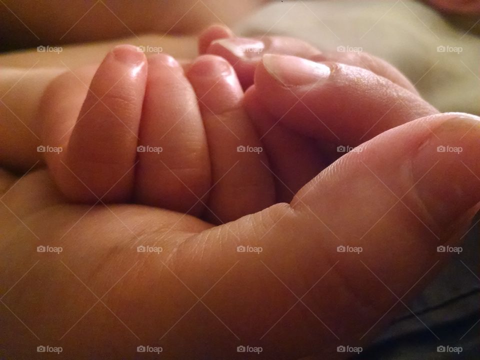 holding baby hands