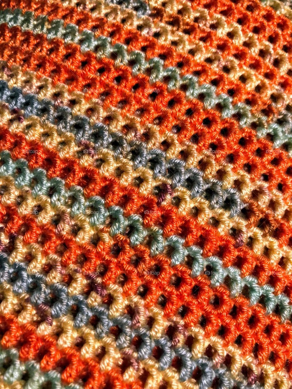 Close up of colorful handmade crocheted item surface