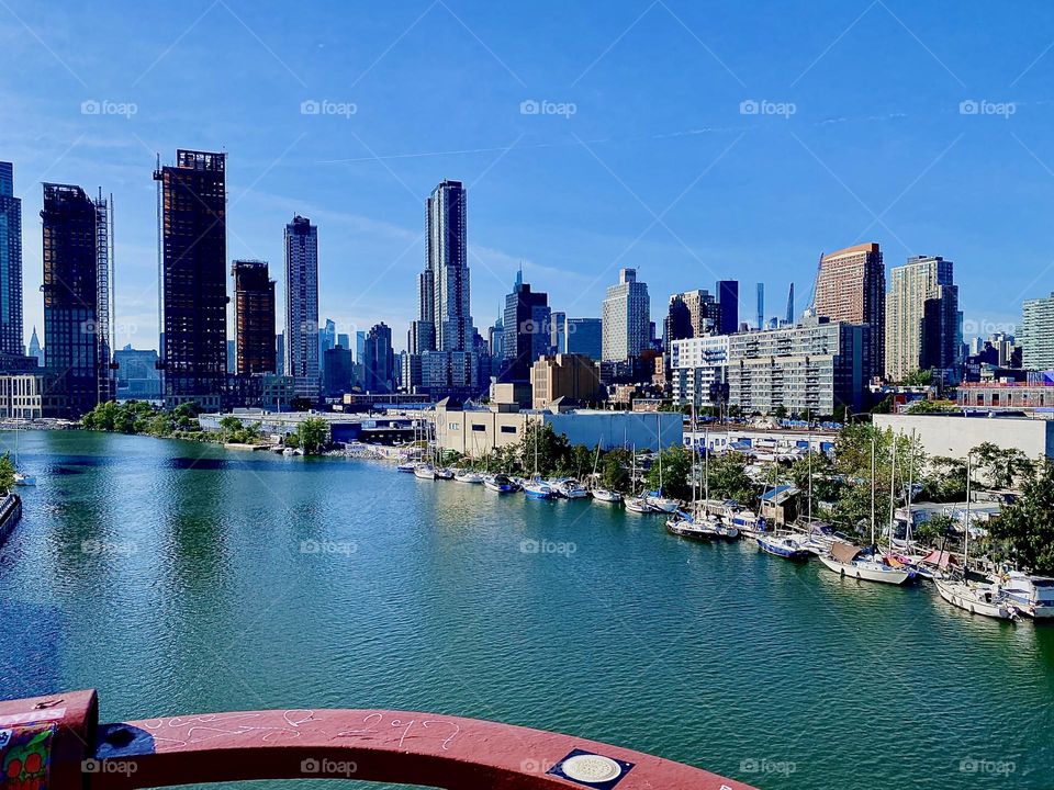 This beautiful panoramic photograph was taken on one of the last really hot and sunny Indian summer afternoons in early October 2023 from the „Pulaski Bridge“ at „Newtown Creek“ in LIC, Queens. 2023. Hypnotic Productions