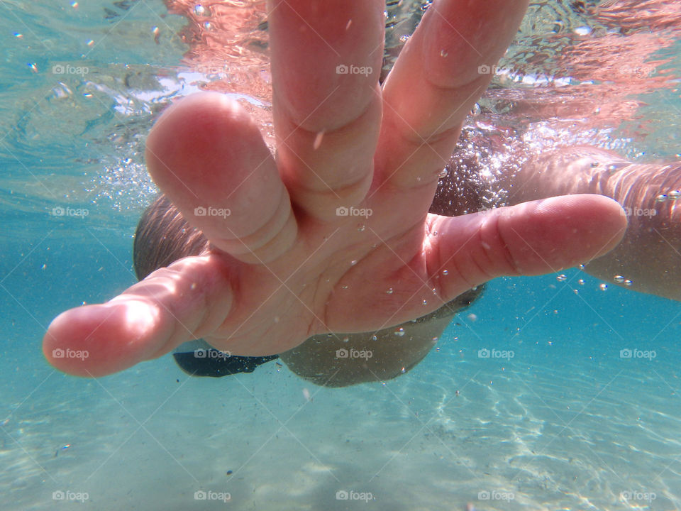 male hand underwater. male hand closeup under the surface of the sea