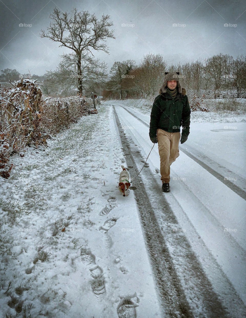 A man walks his dog in the snow in rural France - January 2019