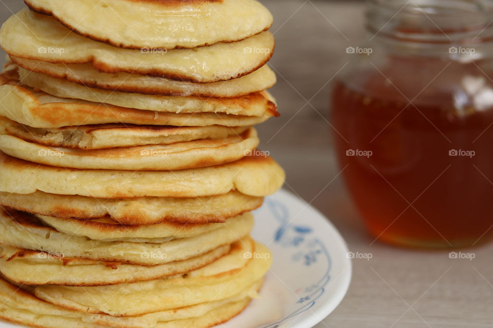 Pile of a freshly made golden pancakes on a plate